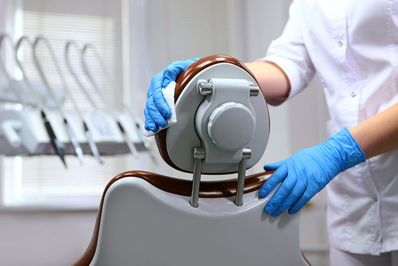 doctor cleaning dental chair