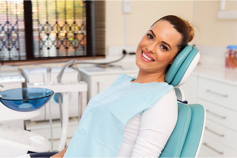 Very nice lady smiling from dental chair
